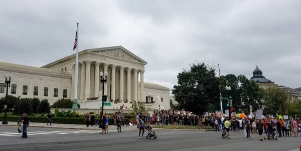 WASHINGTON, DC  - OCTOBER 06, 2018: People hold signs and rally at the Supreme Court to protest the nomination and the Senate vote for the next Associate Justice.