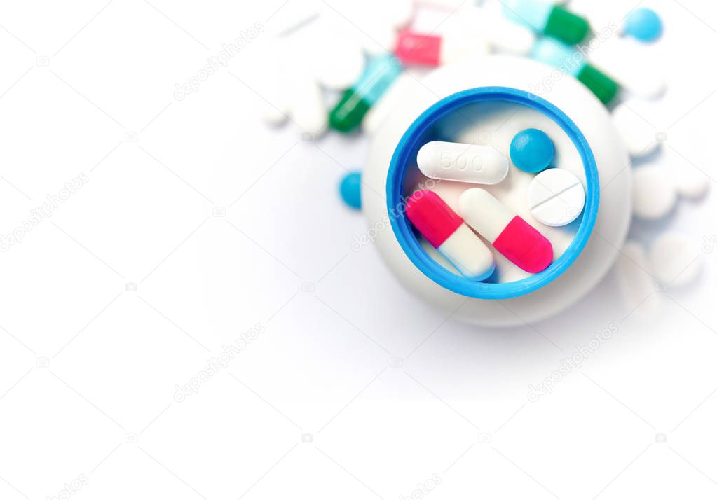 Pills of various colors.The pill is placed in the lid of the medicine bottle.Close ups