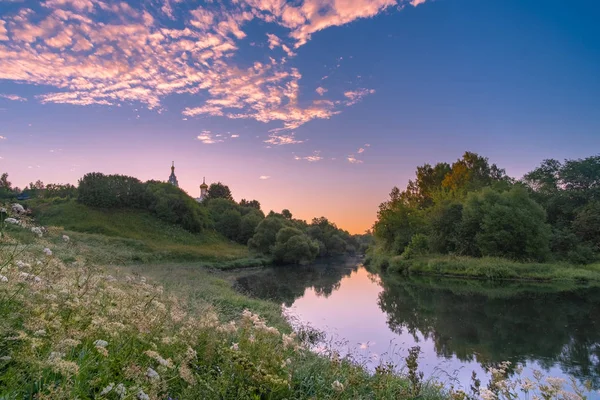 stock image Church on the river at sunrise