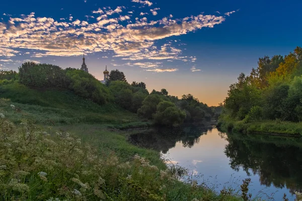 Gereja di sungai saat matahari terbit — Stok Foto