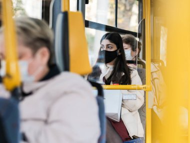 Moskova. - Rusya. 24 Eylül 2020. Şehir otobüsündeki koruyucu maskeli genç bir kıza odaklan. Viral enfeksiyon önleme önlemleri. Toplu taşımacılıkta sosyal uzaklık.