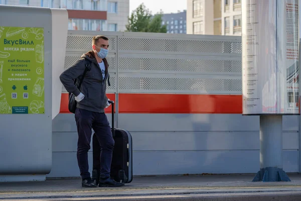 Moskau, Russland. 4. Oktober 2020. Ein einsamer Mann in Schutzmaske und Handschuhen mit einem Koffer am Bahnhof — Stockfoto