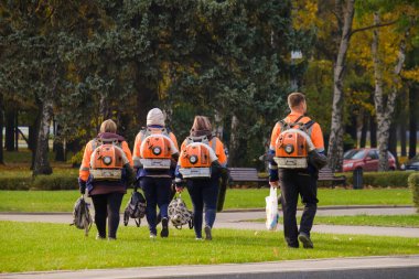 Moskova. - Rusya. 11 Ekim 2020 Sırtında motorlu hava üfleyicileri olan bir grup elektrik işçisi sokakta yürüyor