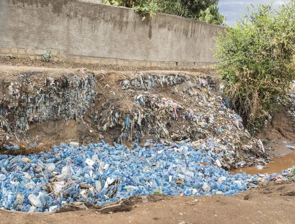 A river in Ethiopia is clogged with empty plastic bottles, environmental disaster.