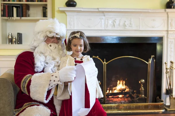 Little girl with missing front teeth asking Santa for gifts