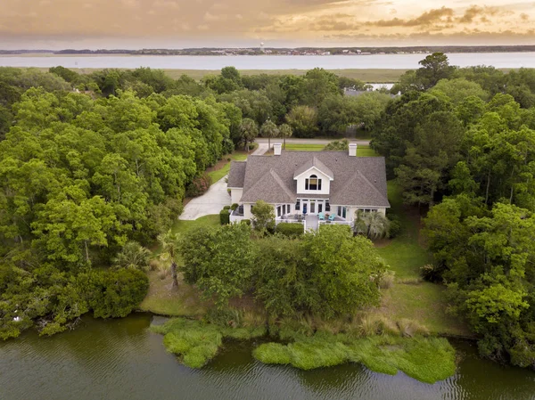 Aerial shot of watefront home with new roof at sunset. — Stock Photo, Image