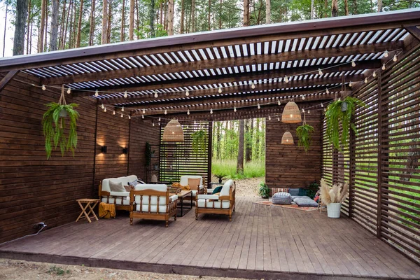 wooden vernada with beautiful furniture in nature