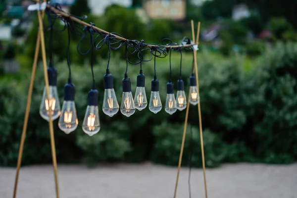 Glass bulbs hang on a stand and glow — Stock Photo, Image