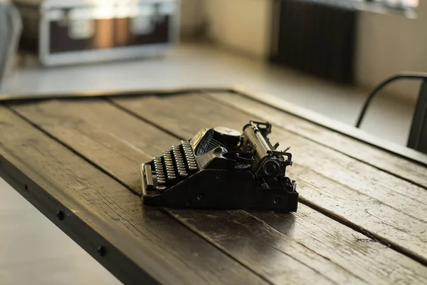 Una máquina de escribir está sobre una mesa de madera — Foto de Stock