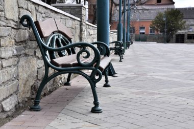bir taş çit arka plan üzerinde parkta büyük demir tezgah