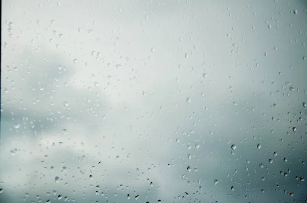 water drops after rain on the glass. Clear glass. It\'s a nasty day.