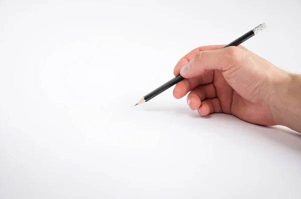 Fekete Ceruzát Tart Jobb Kezében Fehér Háttéren Merít — Stock Fotó