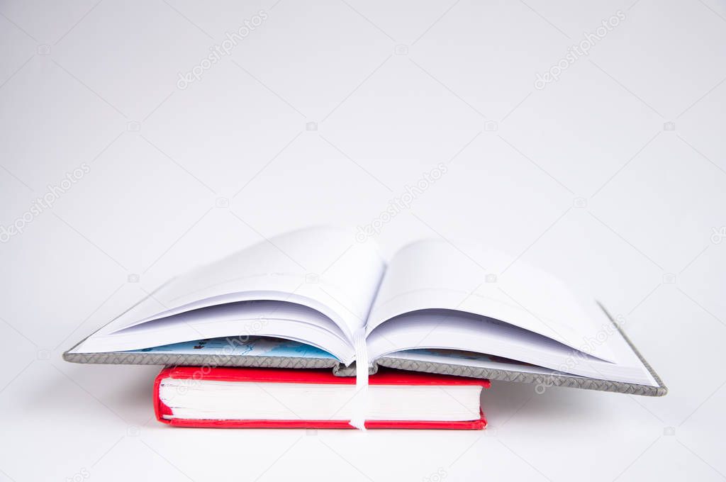 open notebook on the table. On a red notebook On a white background