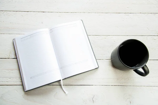 Black Cup Coffee Open Notebook White Table White Wooden Background — Stock Photo, Image