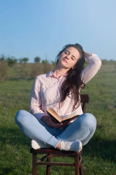 Open book in the hands of a beautiful woman. Young. Outdoors