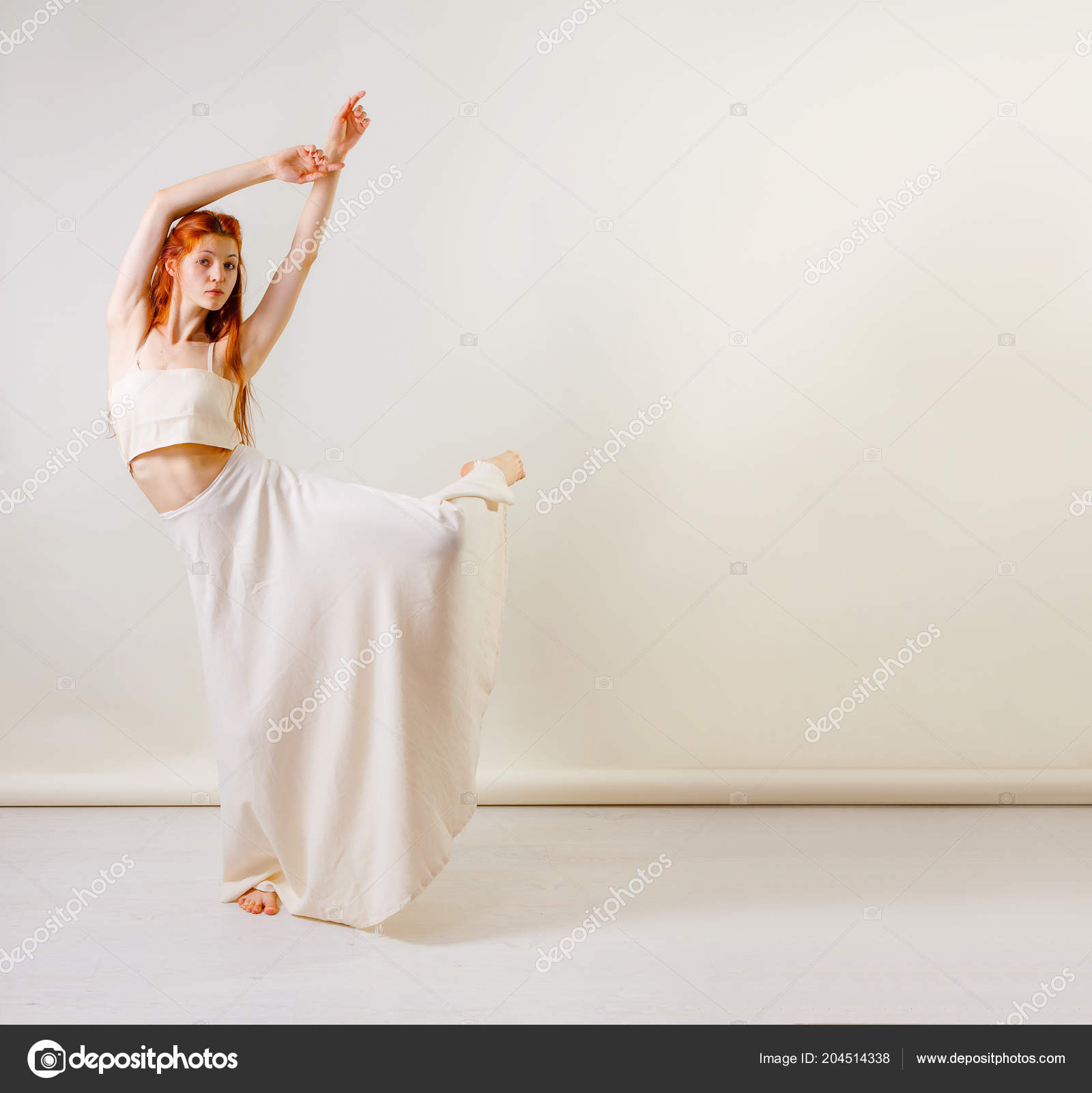 A female model wearing a long cream skirt and fashionable silk blouse poses  in a newly harvested wheat field Stock Photo - Alamy