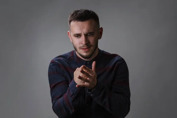 Portrait of angry and evil man hit fist in the palm of your hand desperate feeling sadness facial expression concept on dark gray background