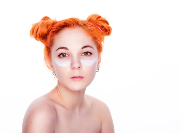 Nahaufnahme Schönheit Porträt eines jungen Teenagers rote Haare und grüne Augen schönes Mädchen Gesichtscreme auftragen. Gesichtsbehandlung. Kosmetik, Beauty und Wellness isoliert auf weißem Hintergrund — Stockfoto
