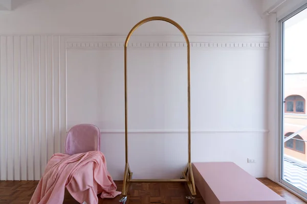 Light interior in pastel colors with velvet chair and mirror frame