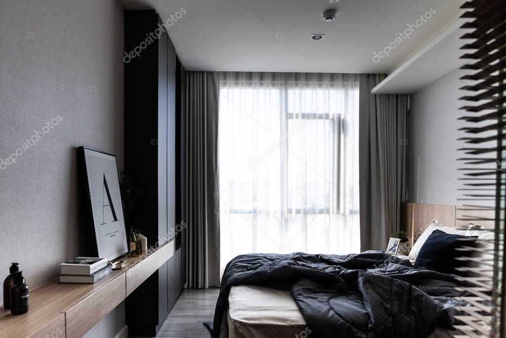 cozy bedroom interior with modern furniture in dark colors