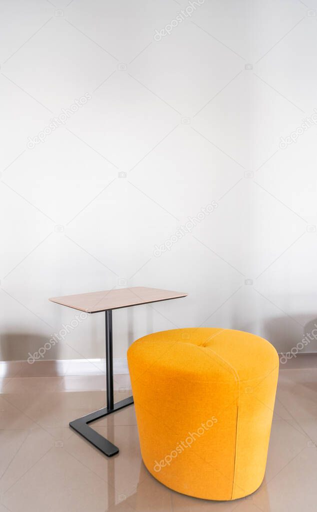 Colorful armchair in minimal modern style with empty wall background in natural light setting / interior / copy space