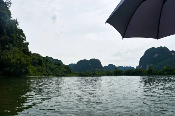 Trang An, Ninh Binh, Vietnam. June 9, 2019: People taking Boat tour to king kong skull island. Trang An is UNESCO World Heritage Site, renowned for its boat cave tours.