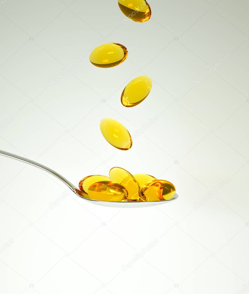 fish oil omega vitamin capsules in spoon on light background 