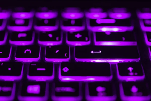 Colorful light keyboard for gaming. Backlit keyboard with versatile color schemes. Light purple