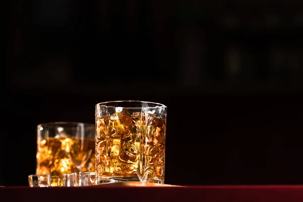 Whiskey glasses with ice in a lounge bar — Stock Photo, Image