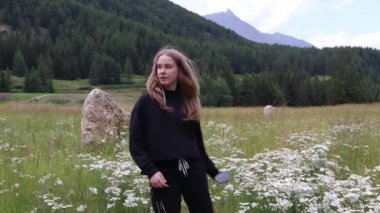 dağlarda bir çim üzerinde duran selfie yapıyor iki küçük kız