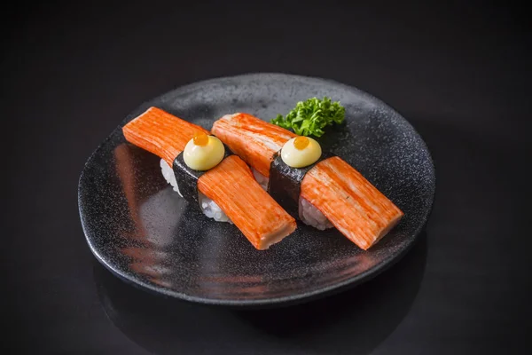 Kani Nigiri, Sushi Kani served on traditional Japanese food on ceramic dish, Japanese food style, Japanese food menu, sushi Kani, Kani sushi on black background, sushi bar Menu, selective focus