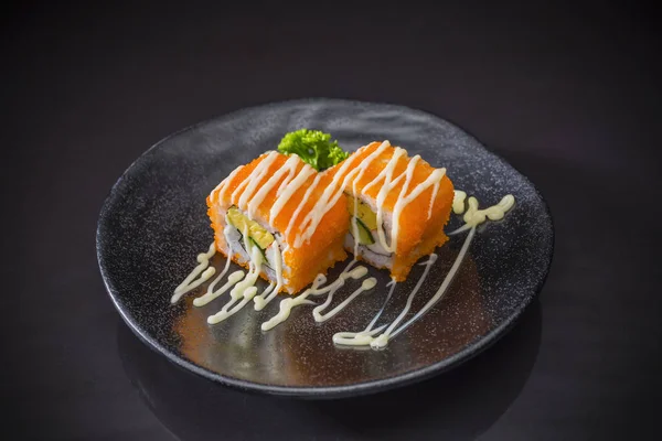 Shrimp egg Roll with mayonnaise sauce served on traditional Japanese food on ceramic dish, Japanese food style, Sushi Menu, Rice roll sushi roll on black background, selective focus