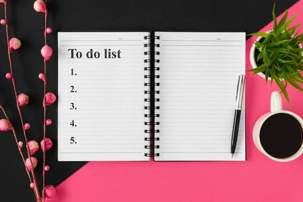 Yapılacaklar listesi için. Defter ve pembe ve siyah arka plan üzerine kahve.