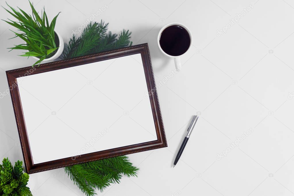 Picture frame with coffee and potted plant on white background.