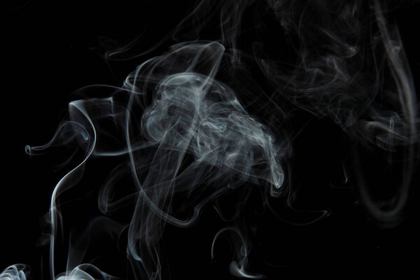 selective focus of smoke flowing on black background