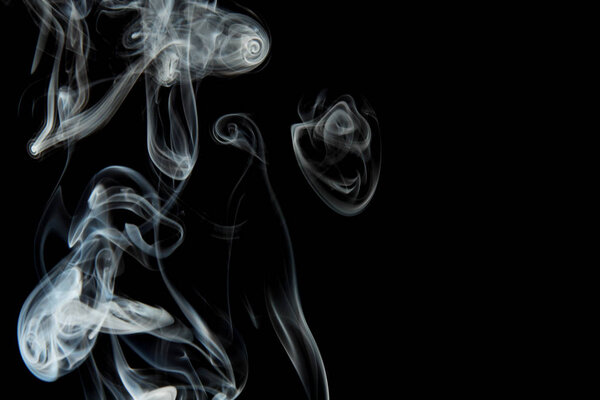 selective focus of smoke flowing on black background
