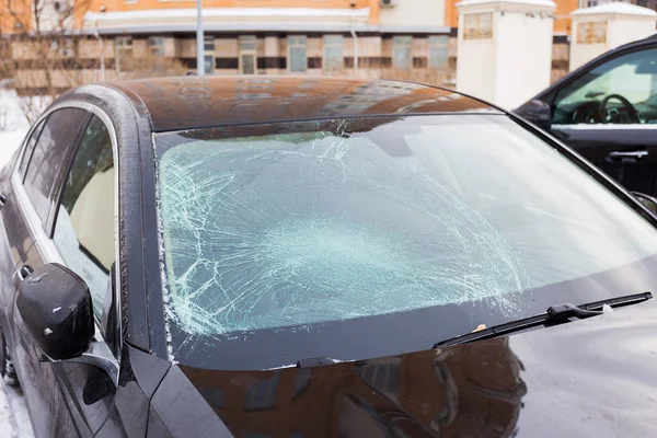 Cracked windshield of the car on the street