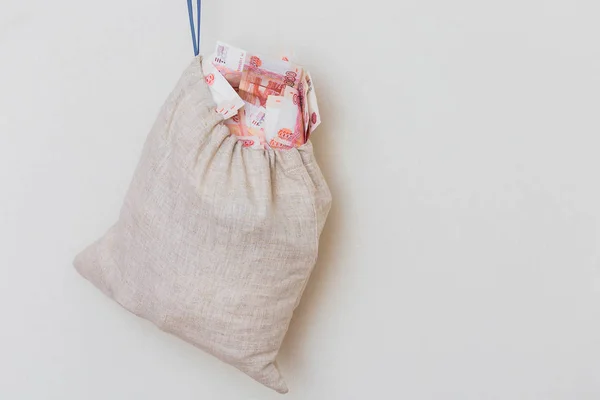 Canvas bag with five thousand banknotes