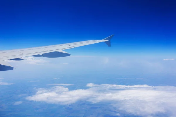 Wing passenger aircraft during the flight on the background