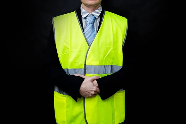 Demonstrators in yellow vests on a black background, the protest of the population in France against the increase in the cost of fuel, excessive living expenses and high taxes, gilets jaunes in French