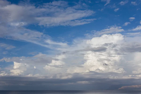 Beautiful fluffy clouds over the sea near Sicily