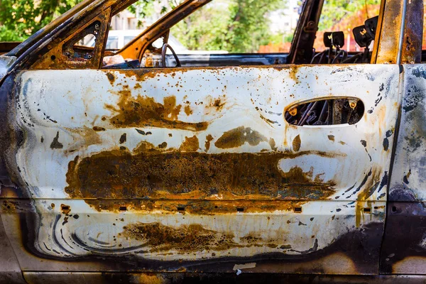 Frame of the burnt car with traces of rust