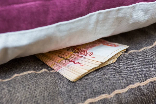 A stack of Russian rubles hidden under the pillow