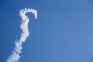 Bulutlar ile mavi bir gökyüzüne karşı beyaz duman izi ile uçak