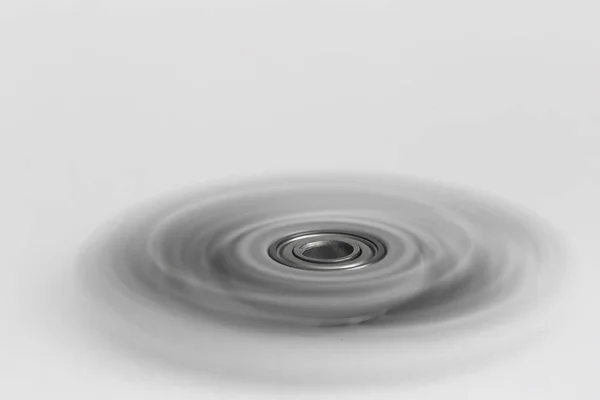 Spinner in motion with blurred blades on white background — Stock Photo, Image