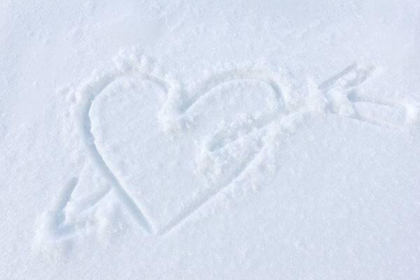 Heart painted on white fluffy snow