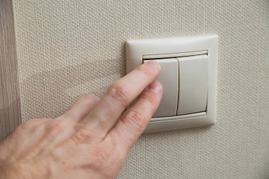 Erkek el ve duvar ışık anahtarı