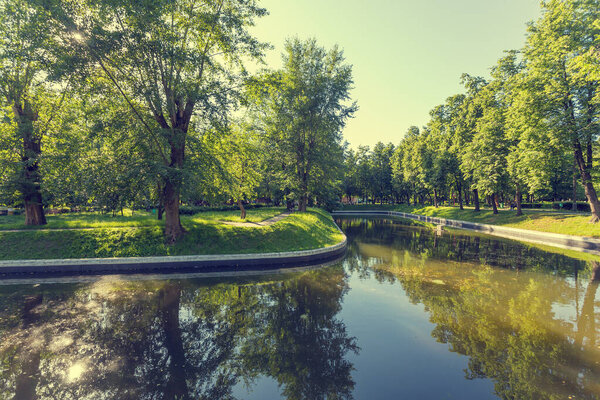 Trubetskoy Park and estate in the Khamovniki district near the Frunzenskaya metro station in Moscow on a Sunny summer day, trees and a pond.