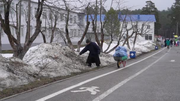 俄罗斯 2019年4月7日 博戈罗迪茨基修道院 一个年长的牧师在阴天清理垃圾 一个男人清理垃圾 — 图库视频影像