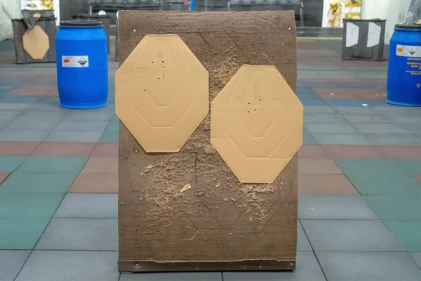 Cardboard silhouette target in the dash. Paper shooting target with bullet holes